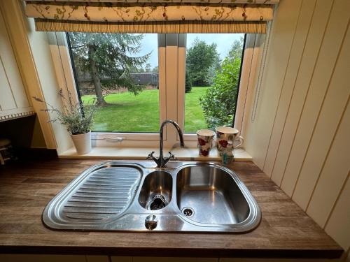 a kitchen sink in front of a window at One Dunbar Court Gleneagles Village in Auchterarder