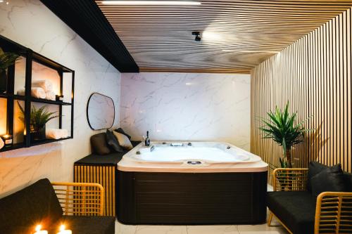 a bathroom with a bath tub and a sink at Villa Gall in Český Krumlov