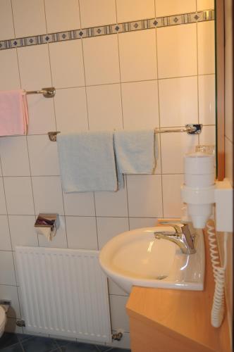 a bathroom with a sink and a toilet and towels at Innviertlerhof in Linz