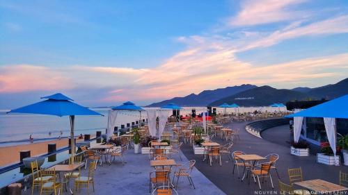 a group of tables and chairs on the beach at FLC Sea Tower Condotel in Quy Nhon
