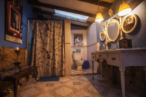 a bathroom with a toilet and a sink and a mirror at Villa de Leyva da Cecy in Villa de Leyva