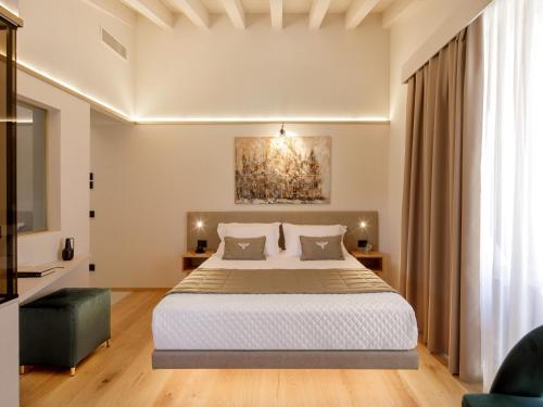 a bedroom with a large bed in a room at Relais Forte Benedek Wine & SPA - Adults Only in Pastrengo
