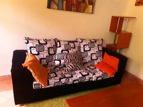 a couch with pillows on it in a living room at New Kitisuru A in Nairobi