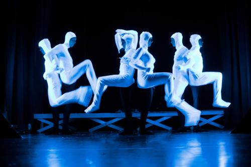 a group of people sitting on a bench in a performance at ROBINSON ALPENROSE Zürs in Zürs am Arlberg