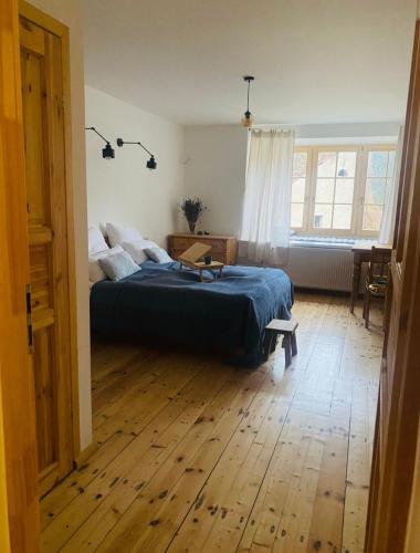 a bedroom with a bed and a wooden floor at Maciejowiec Castle Hill Apartment I in Maciejowiec