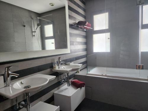 a bathroom with two sinks and a bath tub at Casablanca Marina by Saloua in Casablanca