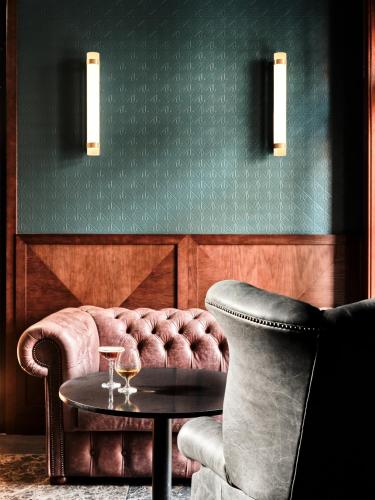 a living room with a couch and a table at The Crown Krakow Center - Handwritten Collection ACCOR in Kraków