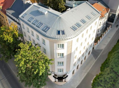 an overhead view of a large white building with a table at The Crown Krakow Center - Handwritten Collection ACCOR in Kraków