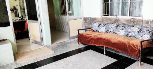 a couch sitting in the middle of a room at Hotel HillView, Junagadh in Junagadh