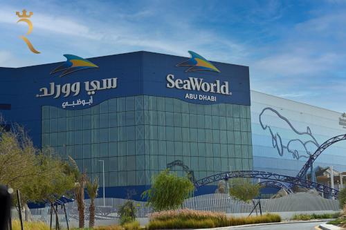 a blue building with a sign on the side of it at Yas Escape - Stylish Boho Studio with Pool, Near Yas Mall in Abu Dhabi