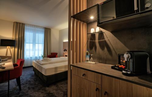 a hotel room with a bedroom with a bed at Hotel & Apart4you in Dorfen