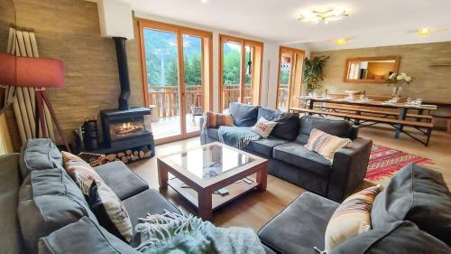 a living room with couches and a fireplace at Chalet Le Refuge in Vaujany