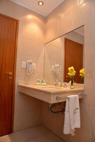 a bathroom with a sink and a mirror at La Campiña Club Hotel & Spa in Santa Rosa