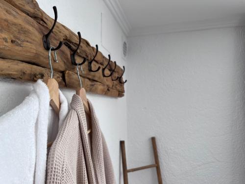 a rack of white towels hanging on a wall at Boutique Casa Lapicida in Calpe