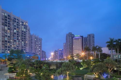 a city skyline at night with tall buildings at Holiday Inn Express Xiamen Lushan -Shopping Center, an IHG Hotel in Xiamen