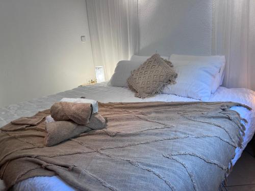 a bed with a blanket and pillows on it at Boutique Casa Lapicida in Calpe