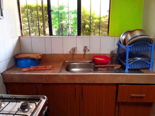 a kitchen counter with a sink and a stove at New Kitisuru D in Nairobi