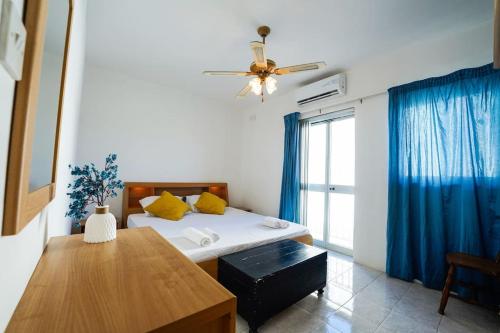 a bedroom with a bed and a ceiling fan at Salina. Peaceful 2 bedroom flat in Naxxar