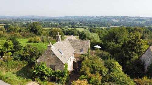 an aerial view of an old house on a hill at Sixpenny Cottage 