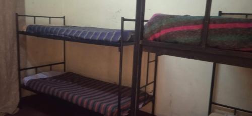 a couple of bunk beds in a room at Kioneki hostels in Nairobi