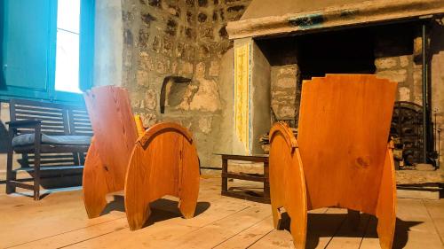 a group of wooden chairs sitting in a room at Inter Artes Prestige House and Luxury Suite in Viterbo
