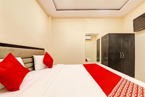 a bedroom with a large bed with red pillows at Hotel Madhav Inn Top Family Hotels Business Hotels Best Couple Friendly Hotel in Lucknow in Lucknow