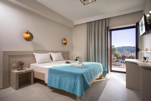 a bedroom with a bed and a large window at Aelia Sivota in Syvota