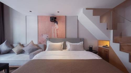 a bedroom with a large white bed with white pillows at Beijing Xin xiang YaYuan Countyard Hotel&NearWang Fu Jing Forbidden City Lama Temple and Summer palace,5 minutes walk from subway ,Free Laundry and coffee in Beijing