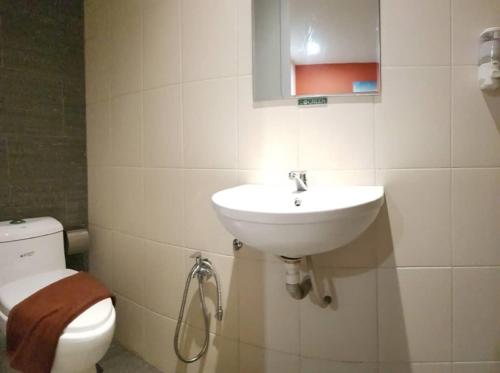a bathroom with a sink and a toilet at Sovotel @ Puchong in Puchong