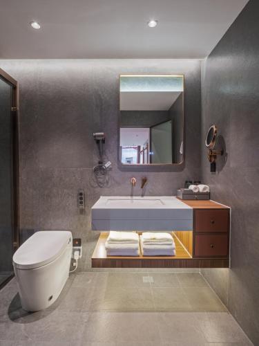 a bathroom with a tub and a sink and a mirror at Beijing Xin xiang YaYuan Countyard Hotel&NearWang Fu Jing Forbidden City Lama Temple and Summer palace,5 minutes walk from subway ,Free Laundry and coffee in Beijing