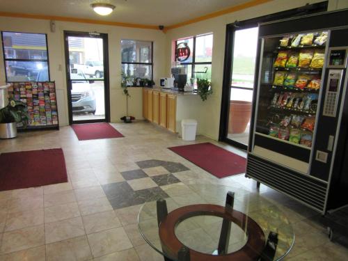 a room with a store with a drink refrigerator at Deluxe Inn Irving in Irving