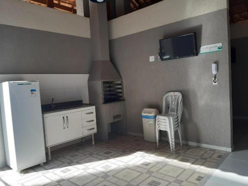 a kitchen with a white refrigerator and a sink at Apartamento em Teresópolis - RJ in Teresópolis