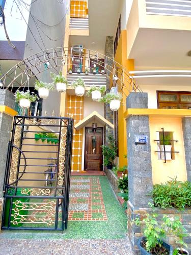 an entrance to a house with a gate and a door at Letters Bà Triệu in Liên Trì (3)