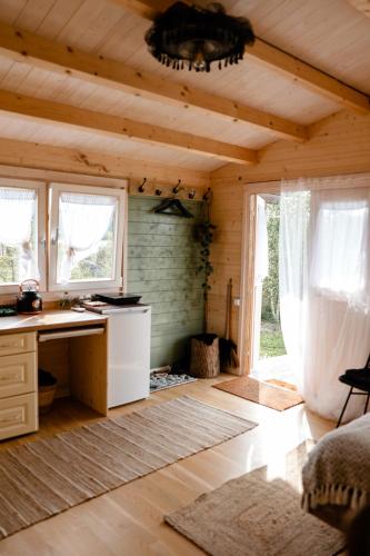 a room with a desk and windows in a cabin at Ambercoast in Jūrmala