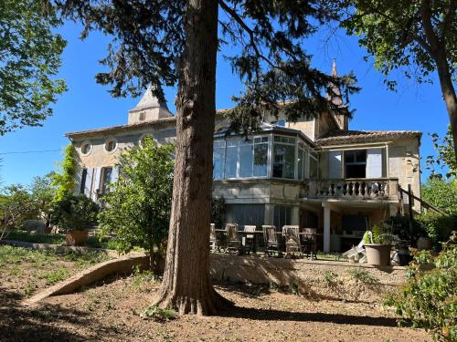 an old house with a tree in front of it at SCI Domaine Saint Martin le grand in Béziers