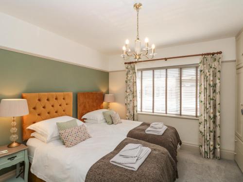 a bedroom with two beds and a window at North Bay Cottage in Bridlington