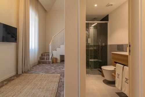 y baño con ducha, aseo y lavamanos. en Silves History Guest House en Silves