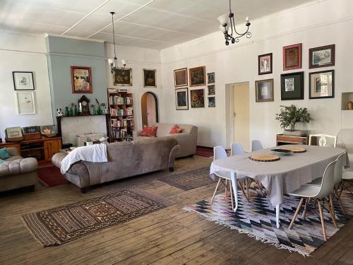 a living room with a table and a couch at RHOOM in Burgersdorp