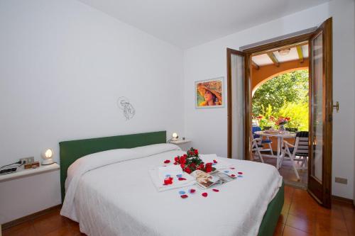 メナッジョにあるMenaggio Poggio Fiorito Loggettaのベッドルーム1室(ベッド1台、花のテーブル付)