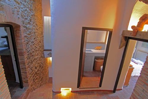 a room with a mirror and a bathroom with a sink at Casa acogedora en Begur in Begur