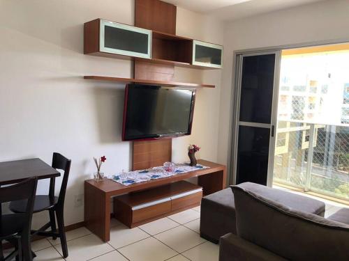 a living room with a flat screen tv on the wall at Lago Norte - CA 05 in Brasilia