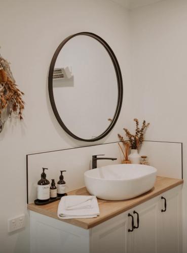 a bathroom with a sink and a mirror at Shack In The Dunes in Weymouth