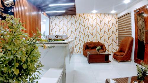 a waiting room with two chairs and a table at The Signature Hotel Multan in Multan