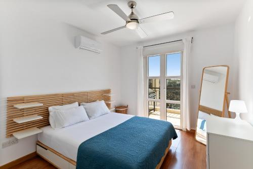 a bedroom with a bed and a large window at Apartment N3 Kallithea in Kouklia