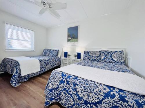 a bedroom with two beds and a ceiling fan at Beach Front Condo with Spectacular Views in Ocean City
