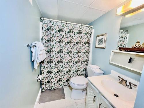 a bathroom with a toilet and a shower curtain at Beach Front Condo with Spectacular Views in Ocean City