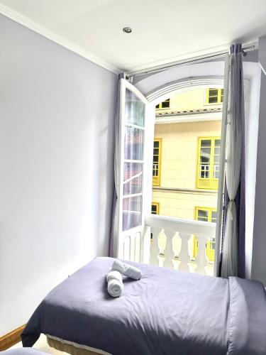 a bedroom with a bed and a large window at La Maresía in Cudillero