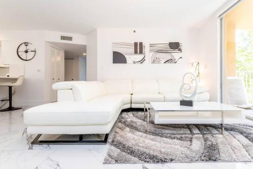 a white living room with a white couch and a table at Luxury VIP 3 Bed 2 Bath Apartment Yacht Club Aventura in Miami