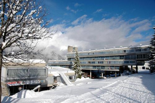 a snow covered street with a building in the background at Ale 1206, Marilleva 1400 accesso diretto alle piste in Marilleva