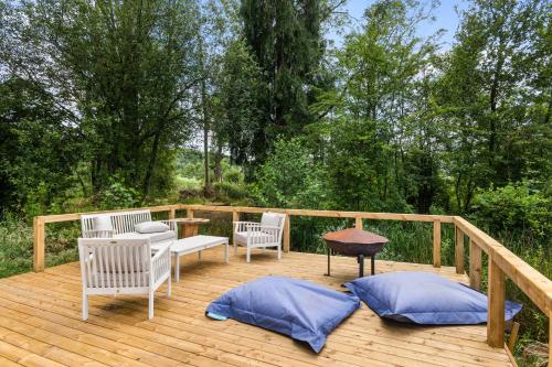 two chairs and a table on a wooden deck at The Bell Tent - overlooking the moat with decking in Evesham